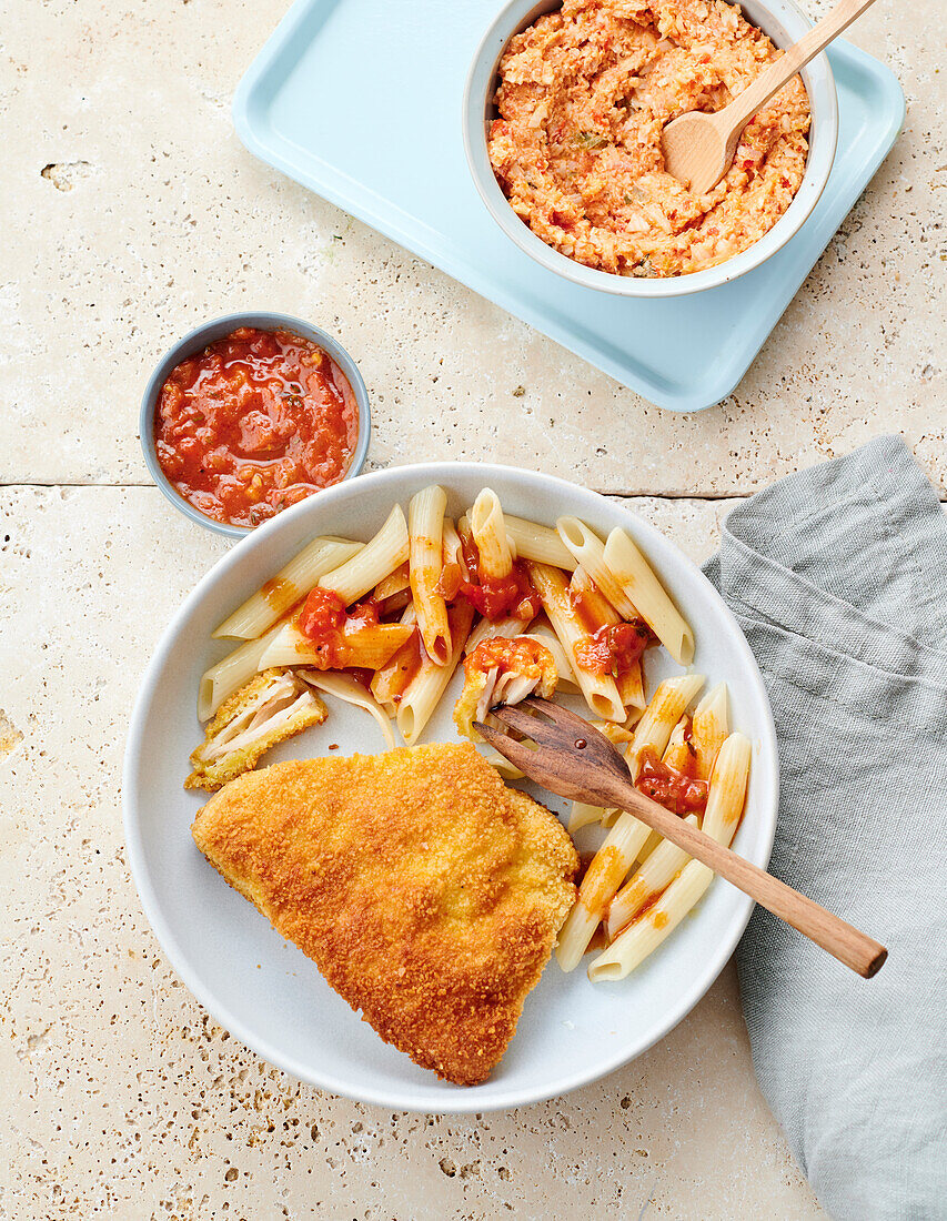 Breaded chicken breast for kids served with penne with tomato sauce