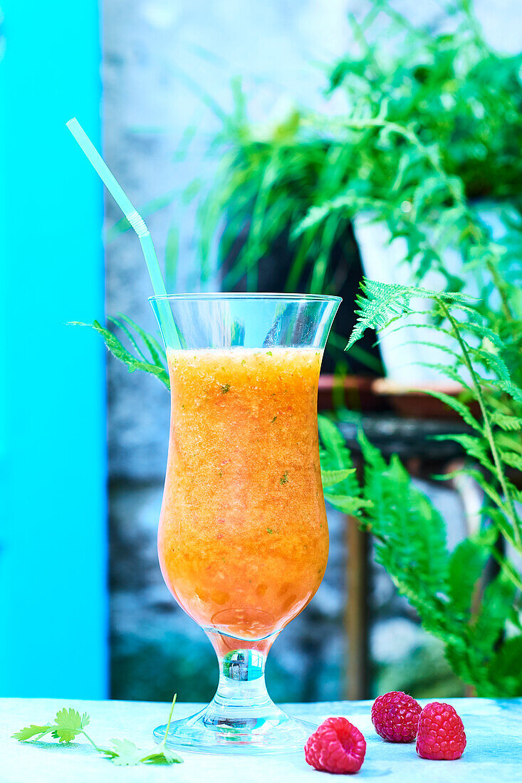 Peach and raspberry cocktail with cilantro