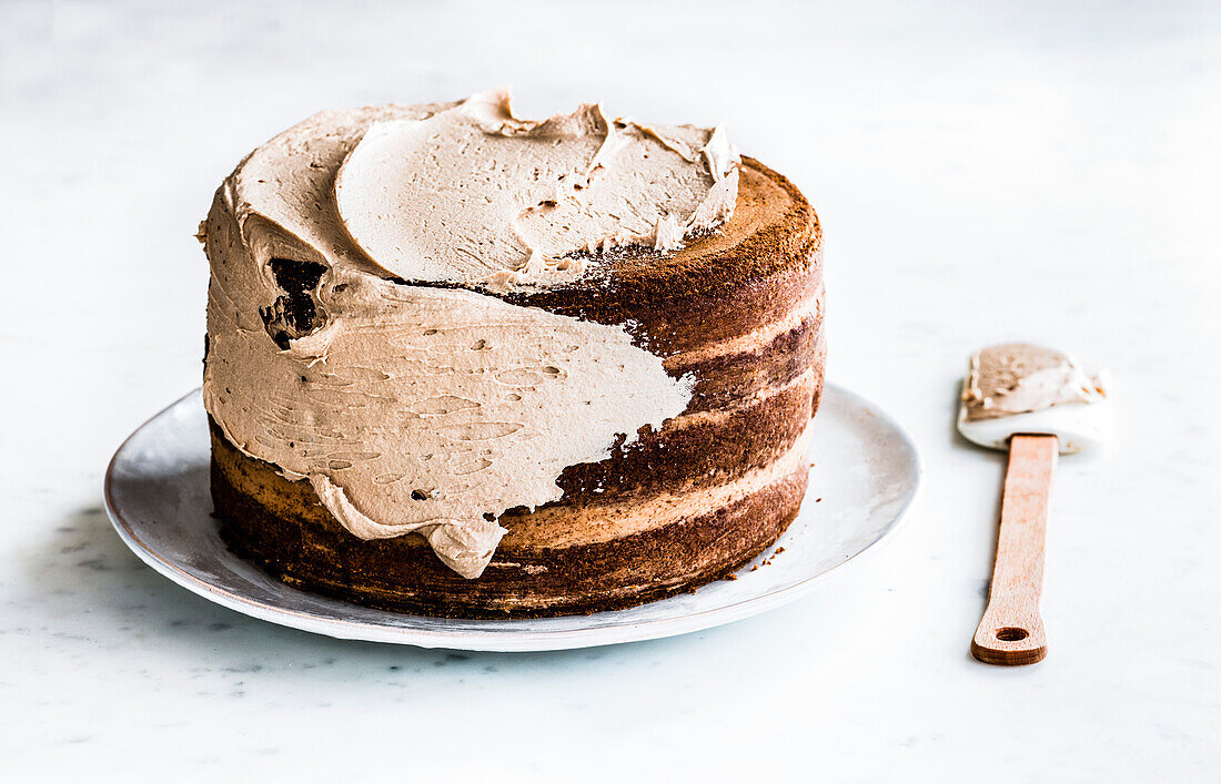 Spreading the frosting on a cake