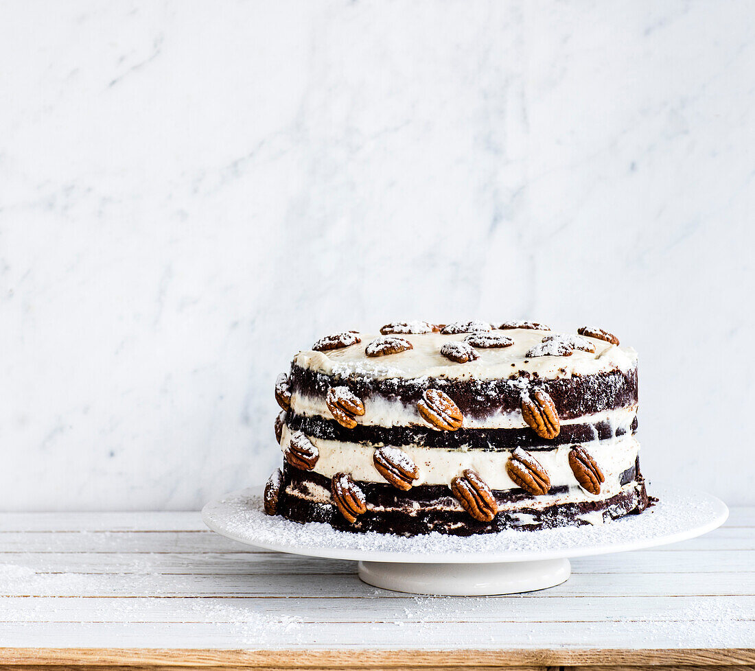 Naked cake with chocolate, cream and nuts