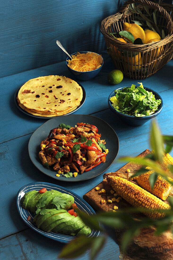 Ingredients for fajitas with chicken, avocado and grilled corn