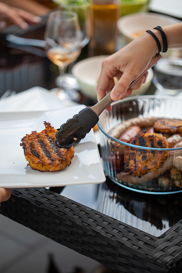 Serving grilled meat on a terrace outdoors