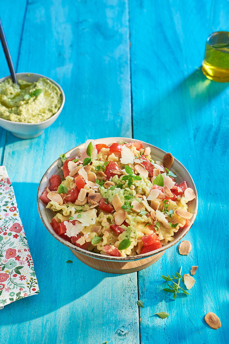 Pasta in courgette cream, tomatoes, flaked almonds and parmesan cheese