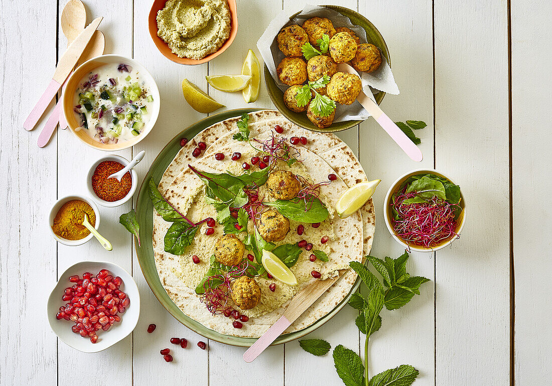 Falafel-Bällchen auf Pitabrot mit Gewürzen und Dips