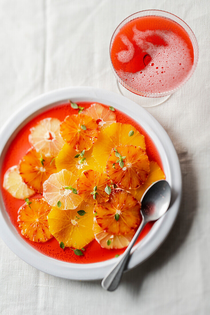 Citrus fruit carpaccio with basil served with cherry beer