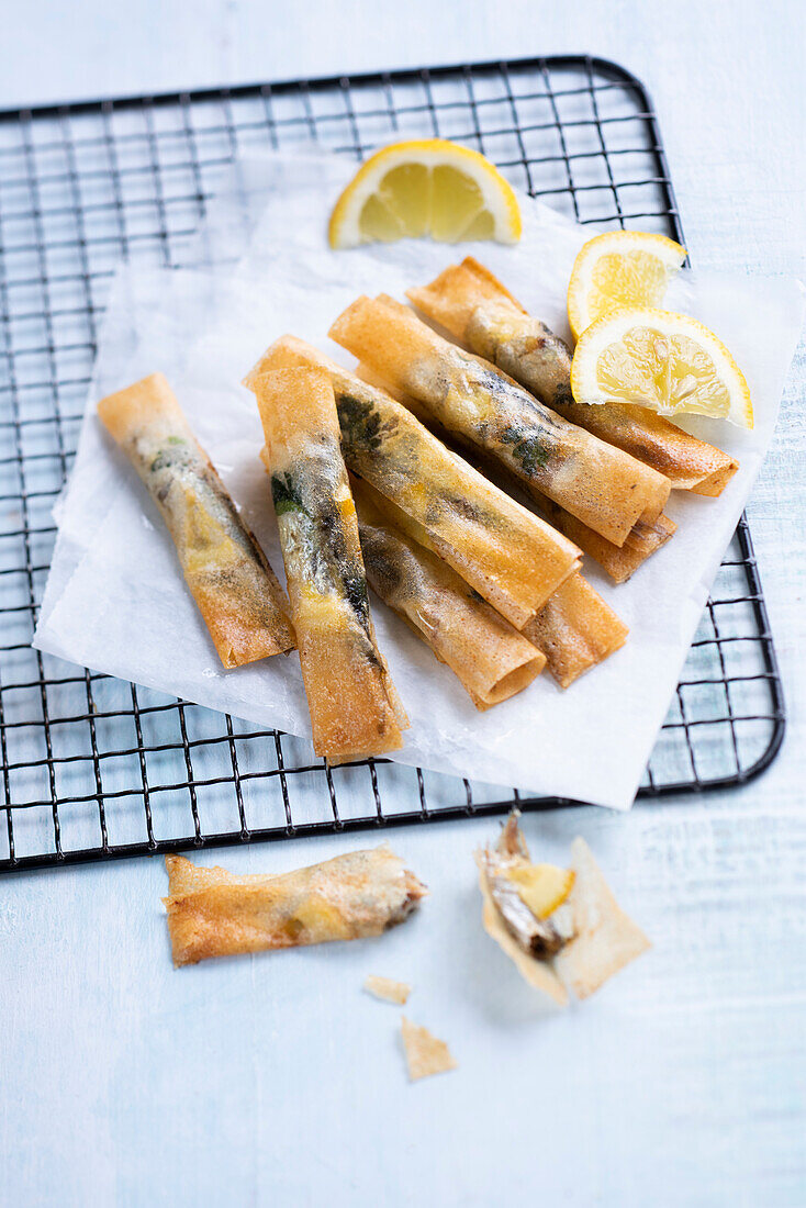 Sardines with lemon, coriander and pine nuts in pastry