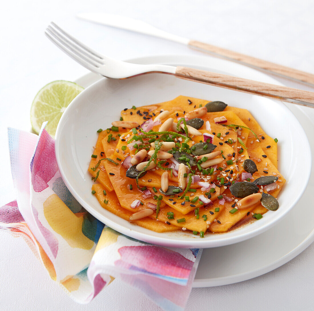 Sliced butternut squash with pumpkin seeds and pine nuts