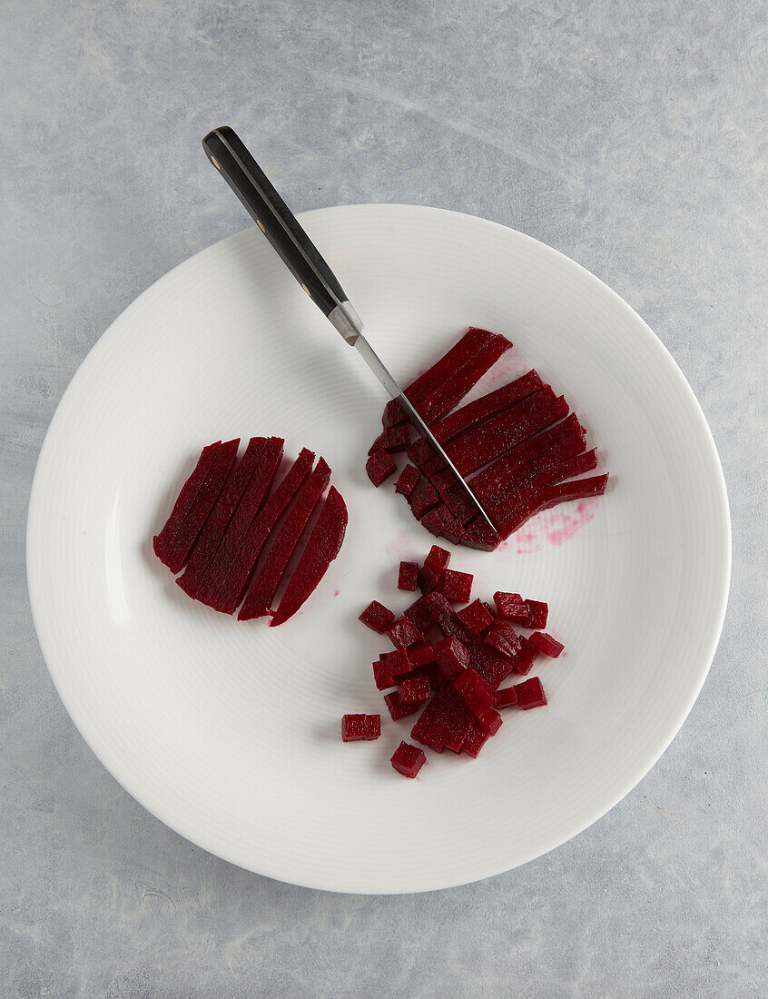 Cutting beetroot slices into strips and cubes