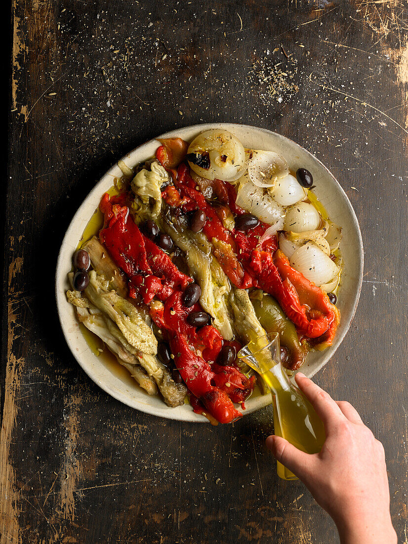 Prepare escalivada (smoky grilled vegetables, Spain): Drizzle vegetables with oil