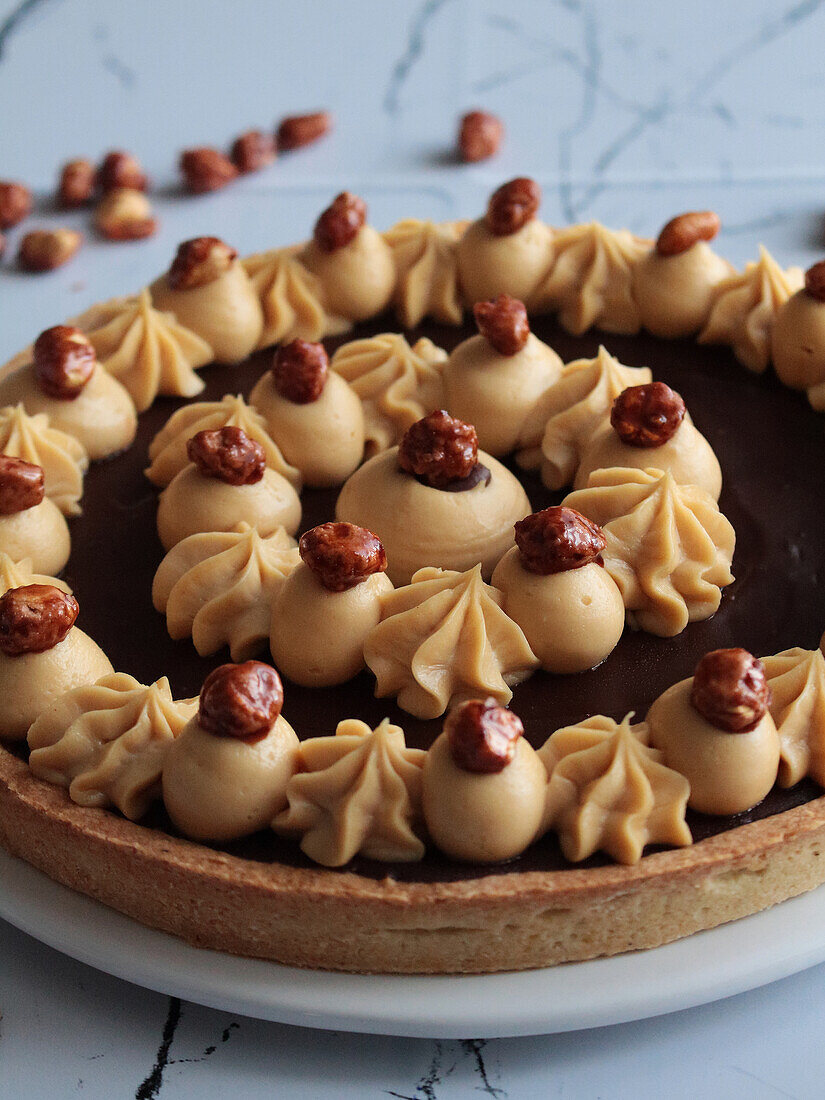 Dark chocolate tart with pralines and hazelnuts