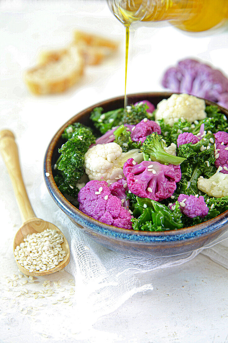 Cabbage salad with broccoli, white and purple cauliflower