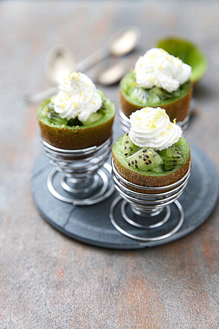 Kiwi salad with lavender honey and cream served in hollowed kiwi fruits