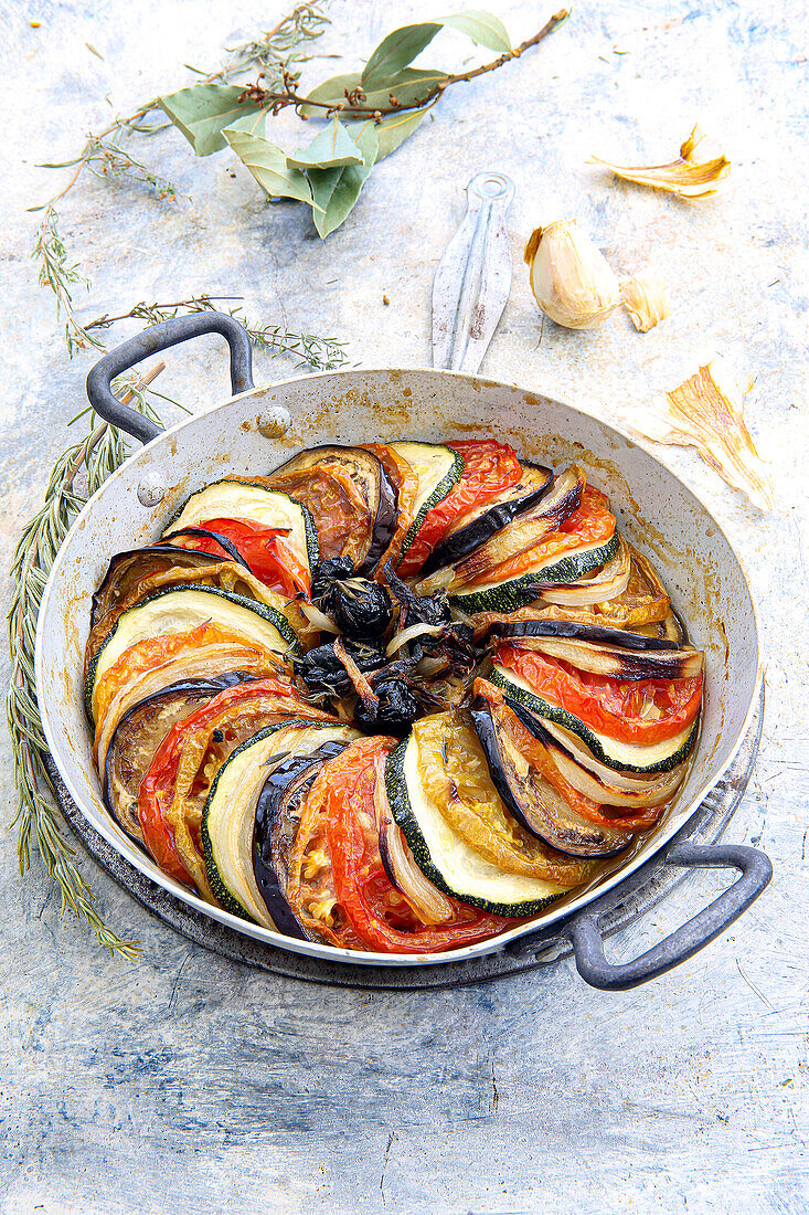 Tian with tomatoes, aubergines, courgettes, olives and candied garlic