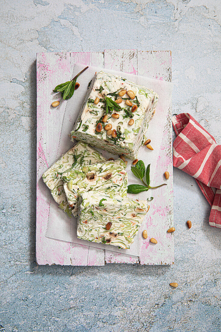 Cucumber and fresh cheese terrine with dried tomatoes, pine nuts and mint