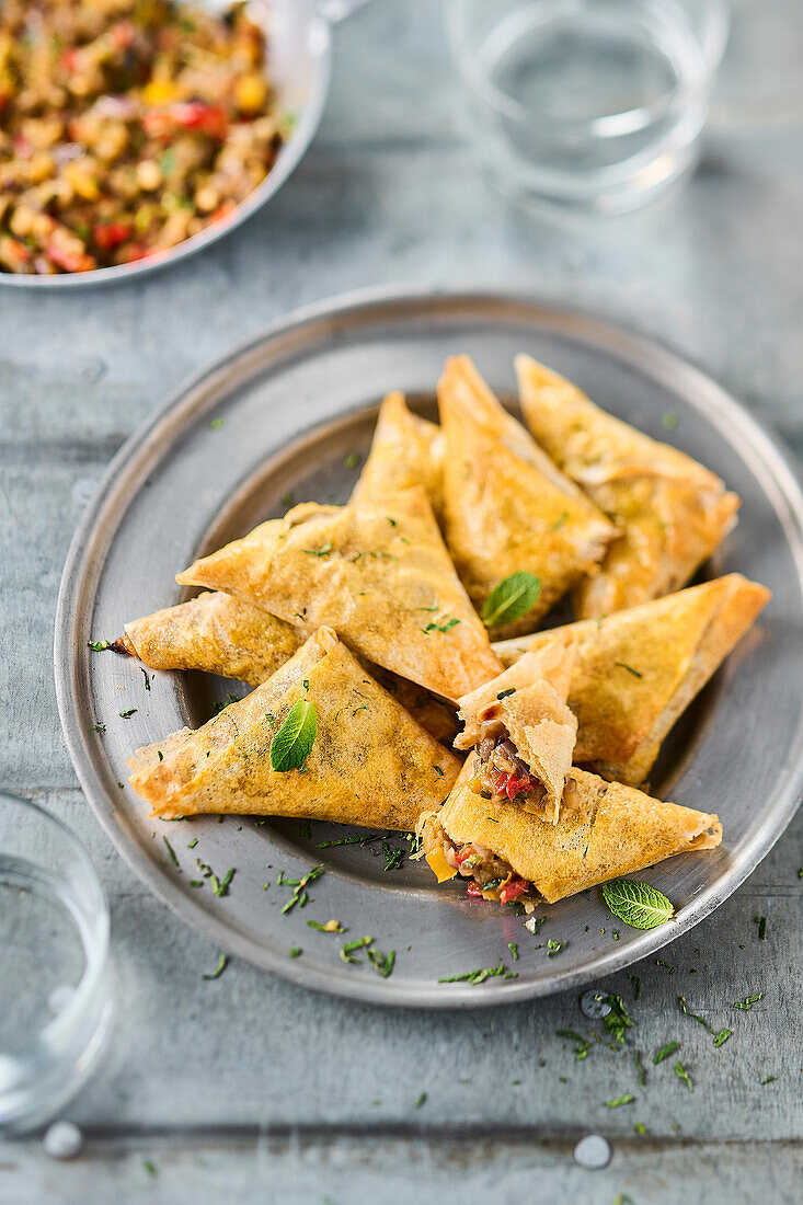 Samosas with pickled vegetables, anchovies and mint