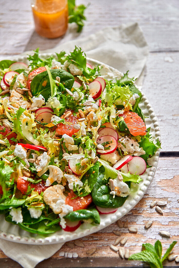 Vitamin-rich salad with grapefruit, radishes, spinach and cauliflower