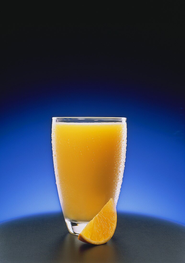 Tall Redfreshing Glass of Orange Juice; Orange Wedge
