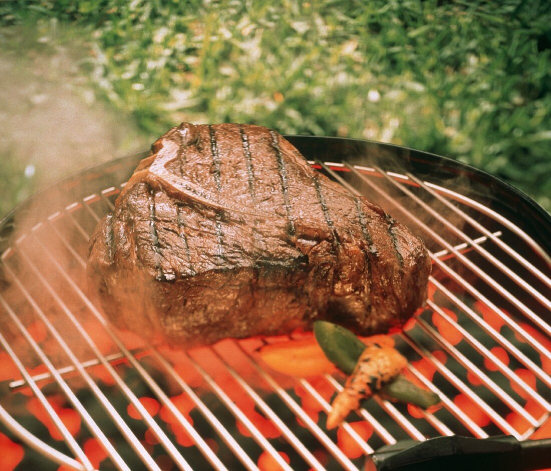 T-Bone Steak on the Grill with Vegetables; Steam