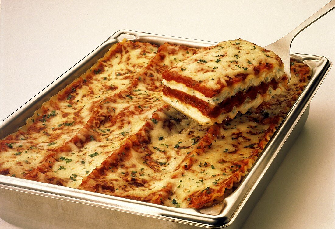 Lasagna in a Pan; a Serving on a Spatula