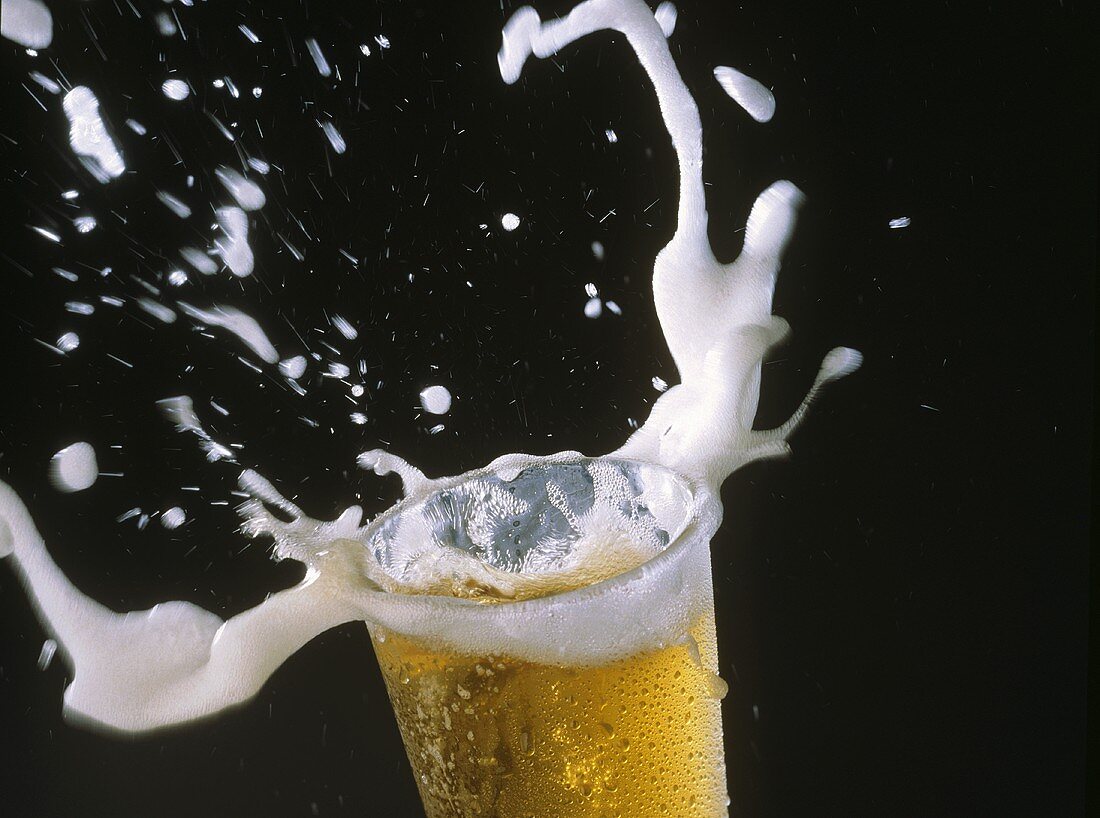 Glass of Beer with Spraying Foam