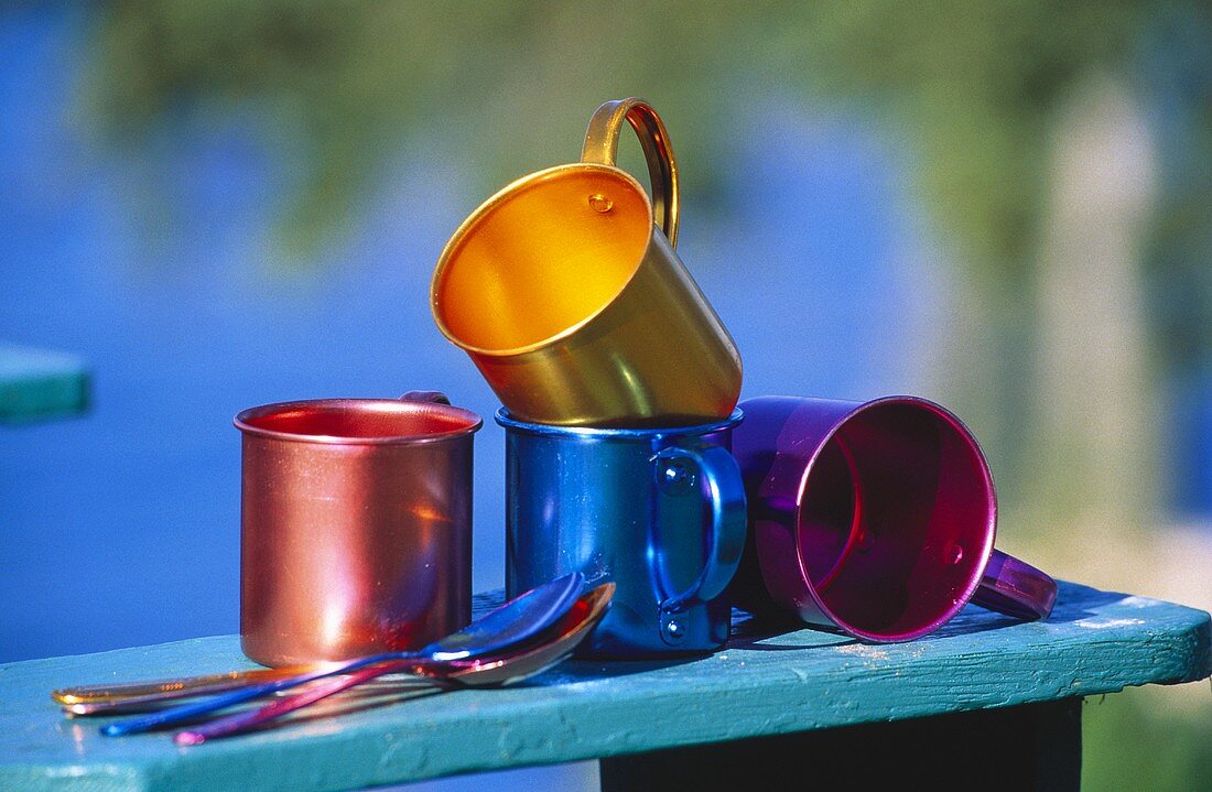 Colorful Tin Cups on the Arm of a Chair