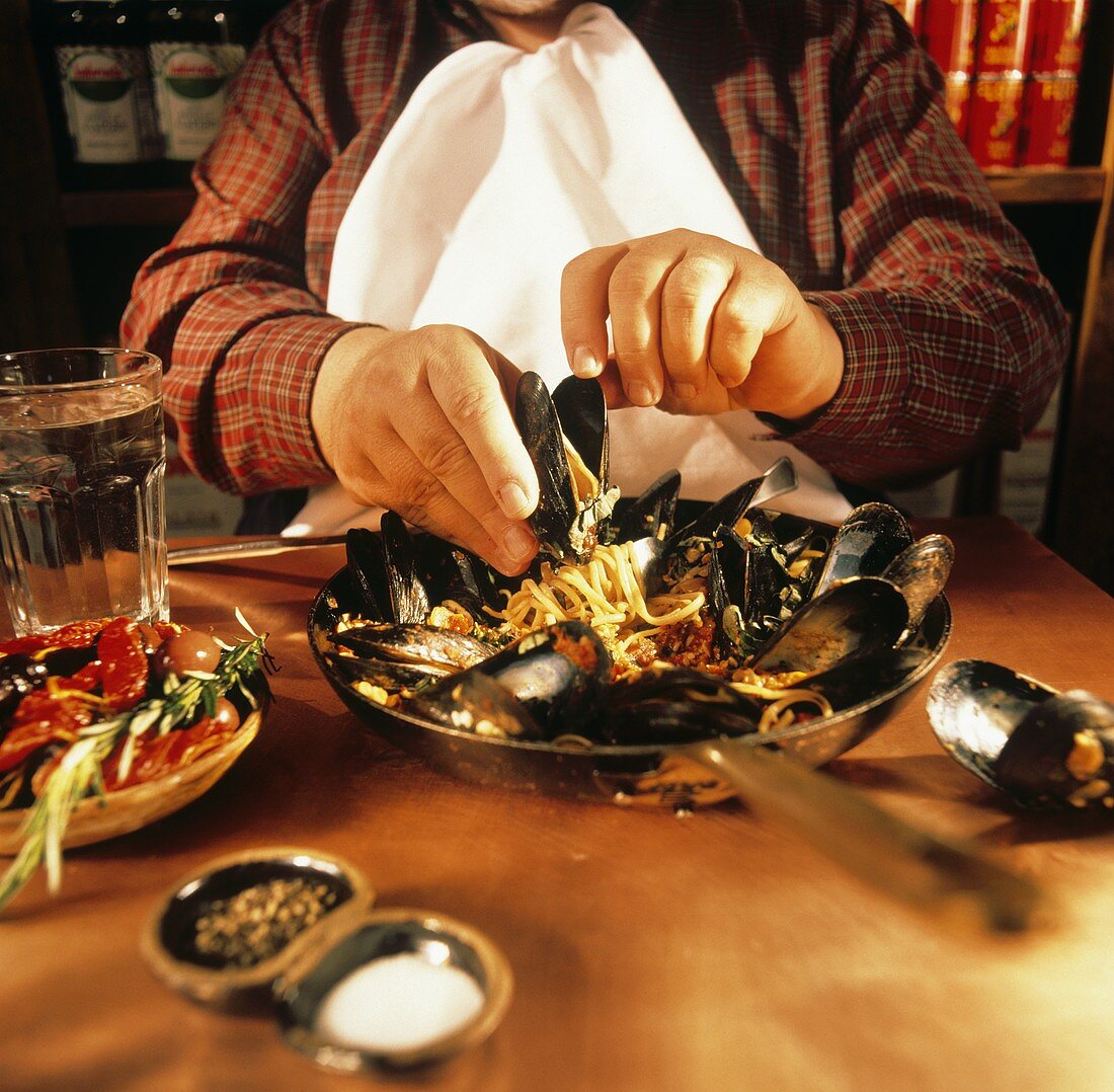 Man Eating Mussels with Linguine