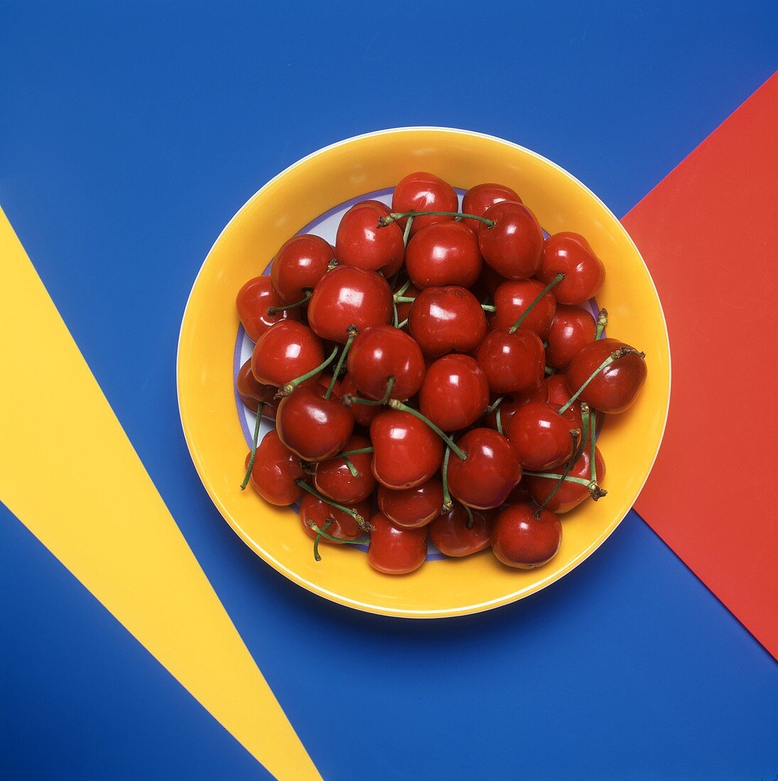 Fresh Red Cherries on a Yellow Plate
