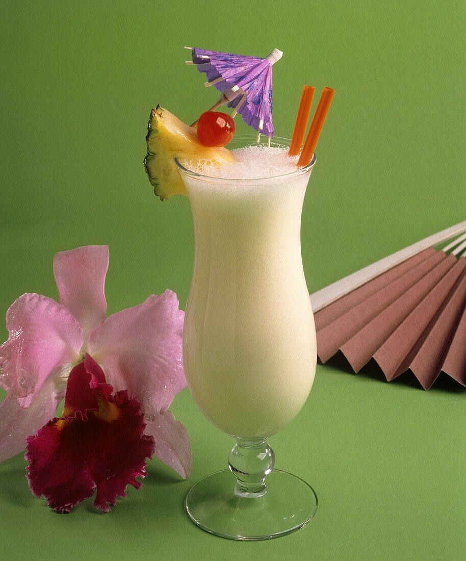 A Glass of Pina Colada with Fruit and a Cocktail Umbrella