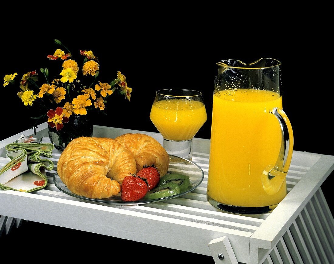 Croissants Fruit and Orange Juice on a Tray