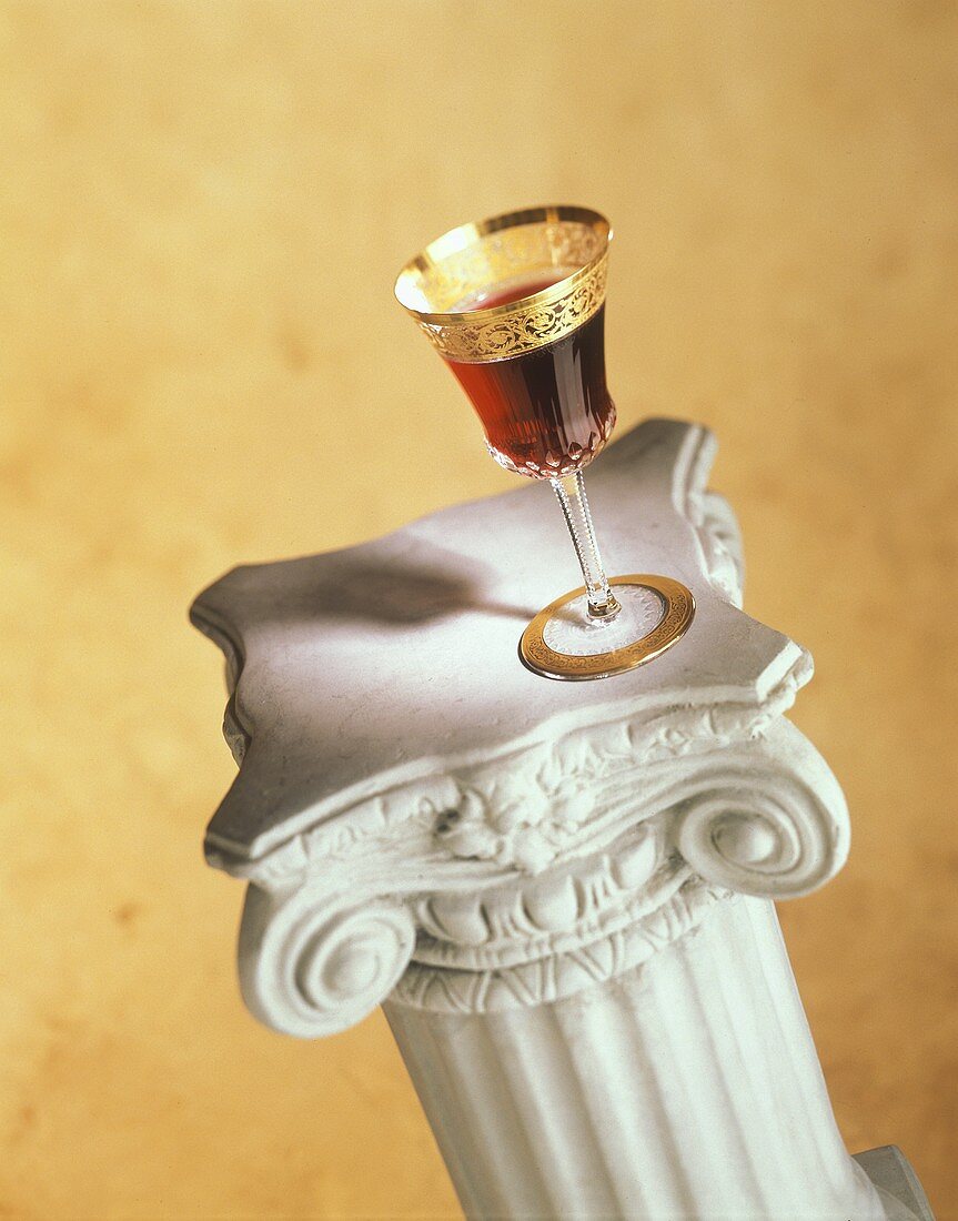 Elegant Glass of Red Wine on Stone Column