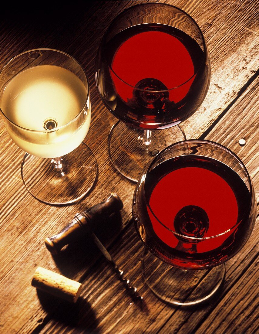 Zwei Rotweingläser, ein Weissweinglas, Korken, Korkenzieher
