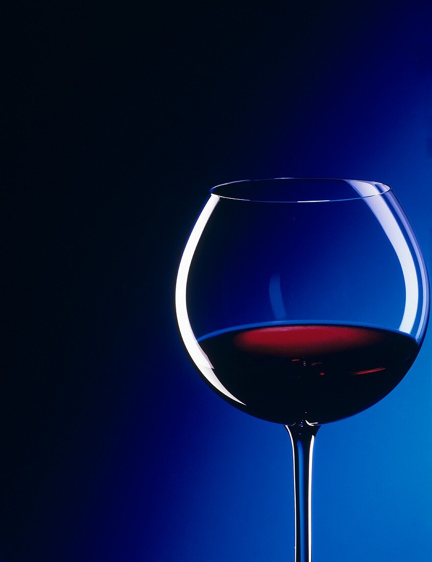 Glass of Red Wine with Blue Background