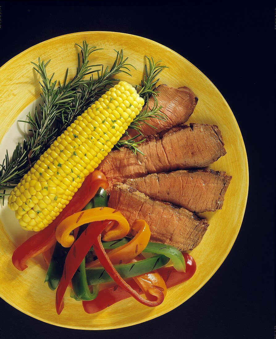 Sliced Steak with Grilled Bell Peppers and Corn on the Cob