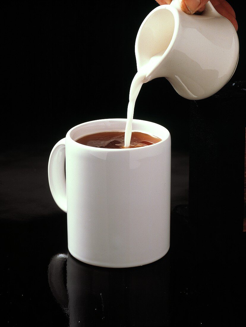 Pouring Cream into Coffee