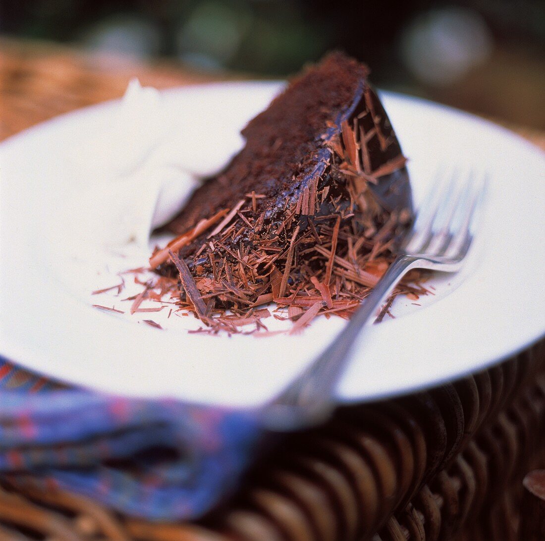 Ein Stück Schokoladenkuchen mit Schokospänen und Sahne