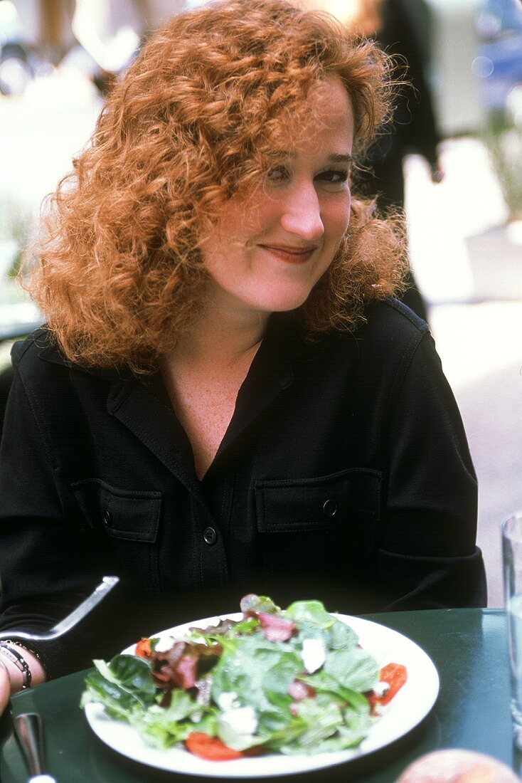 Woman with a Salad at an Outdoor Table