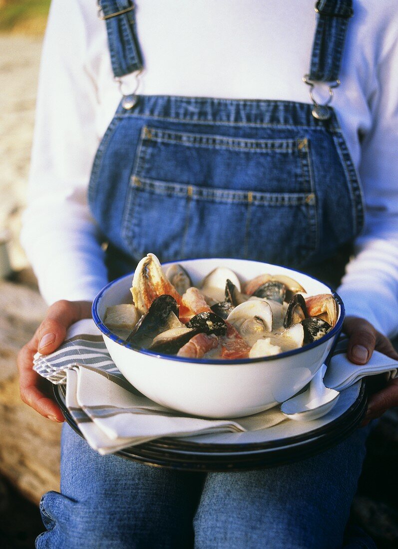 Woman Holding Shellfish Stew