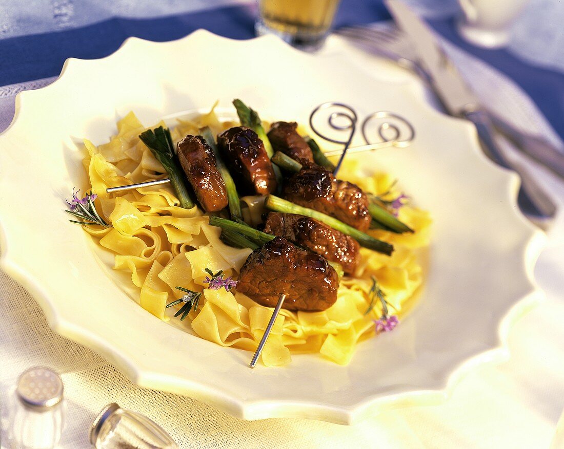 Skewered Beef Medallions Over Eggs Noodles