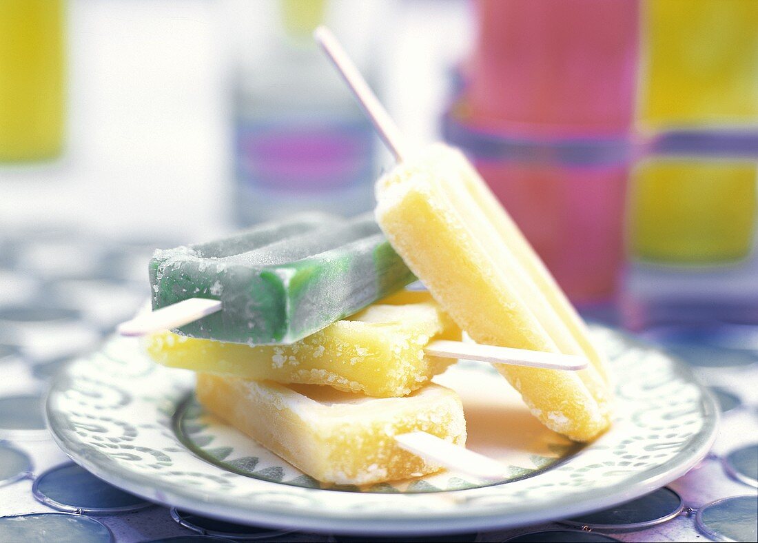 Four Citrus Popsicles in a Stack on a Plate