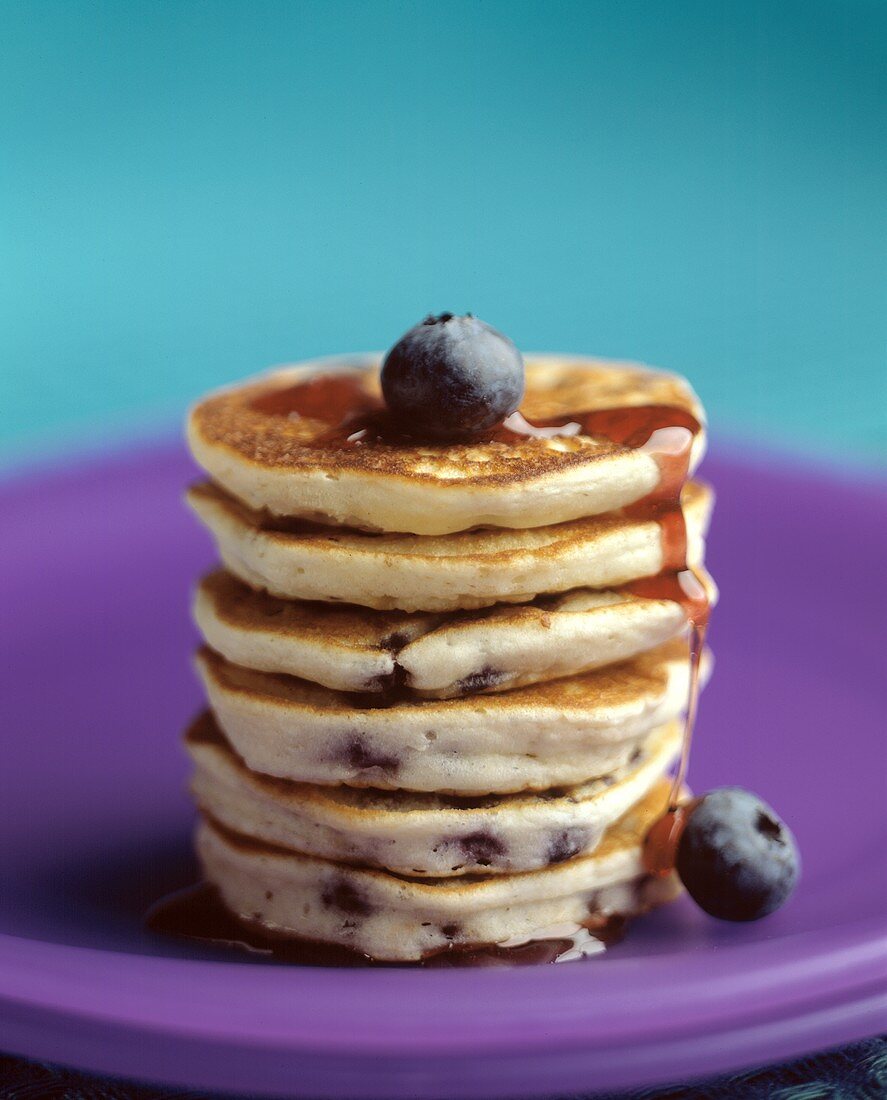 A Stack of Mini Blueberry Pancakes with Syrup
