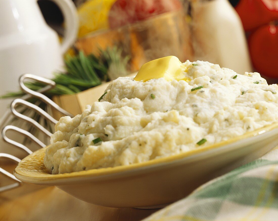 A Bowl of Chive Mashed Potato with Melting Butter
