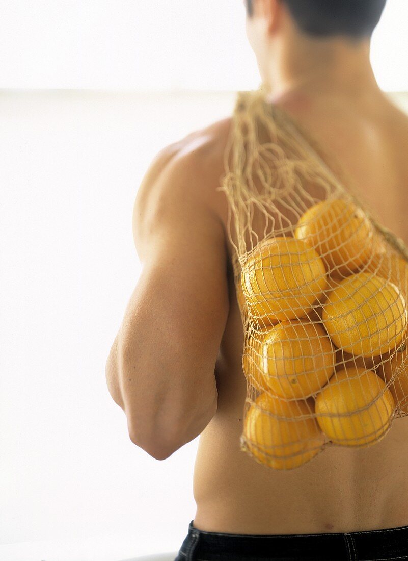 A Bag of Oranges Over a Man's Shoulder