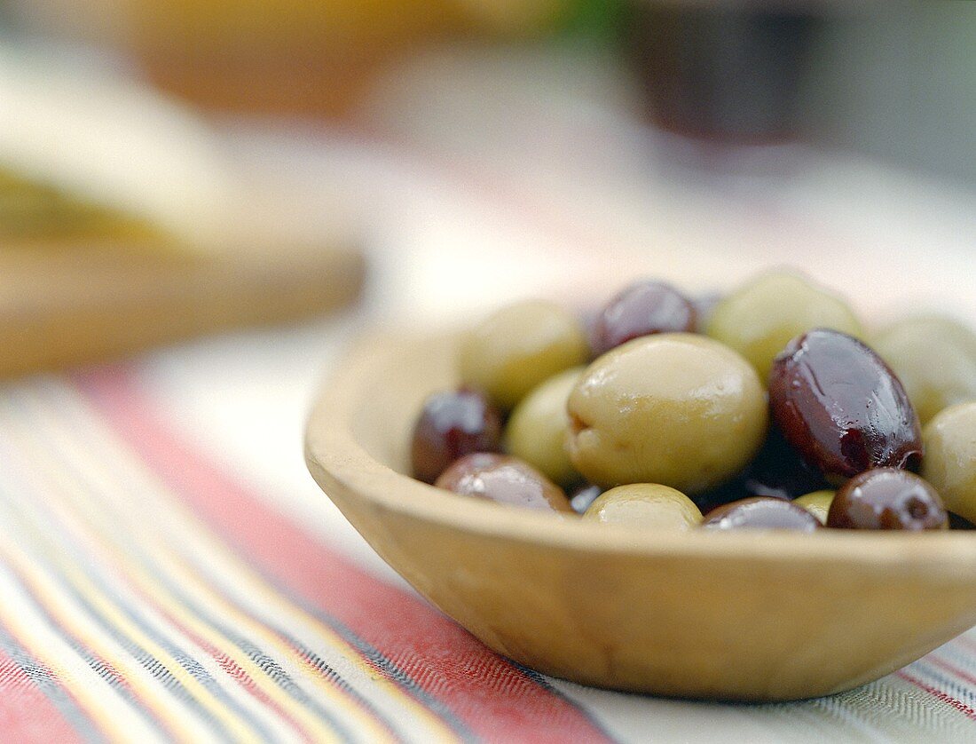 Mixed Olives in a Bowl on a Striped Towel