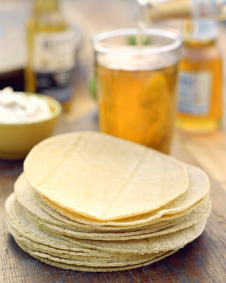 A Stack of Flour Tortillas with a Glass of Beer