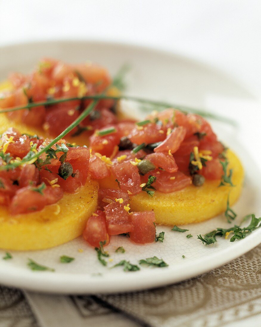 Tortini di polenta (Polenta rounds topped with tomatoes & capers)