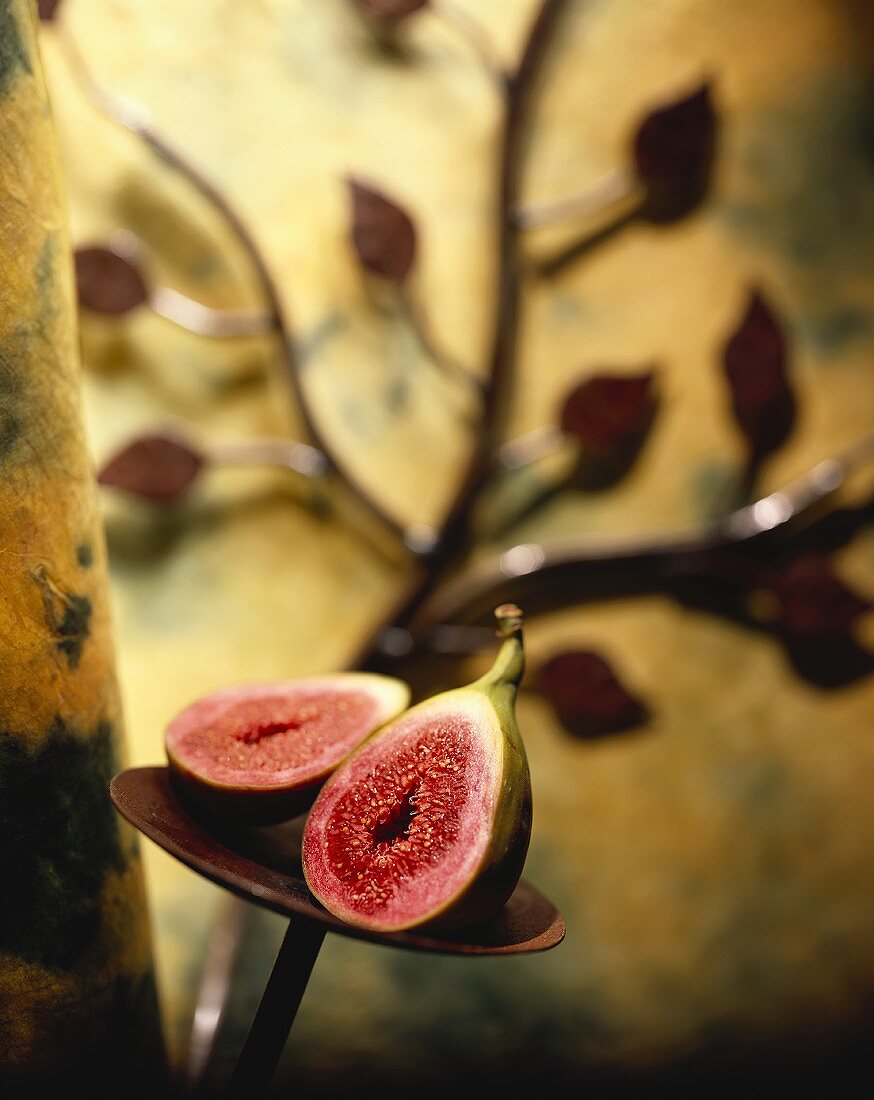 A Halved Fig on a Stand with Metal Leaves