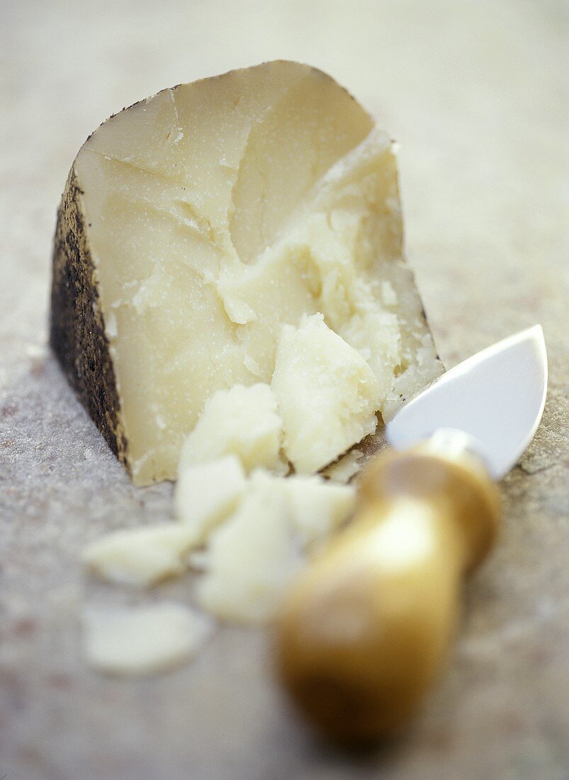 A Wedge of Pecorino Romano Cheese with Cheese Knife