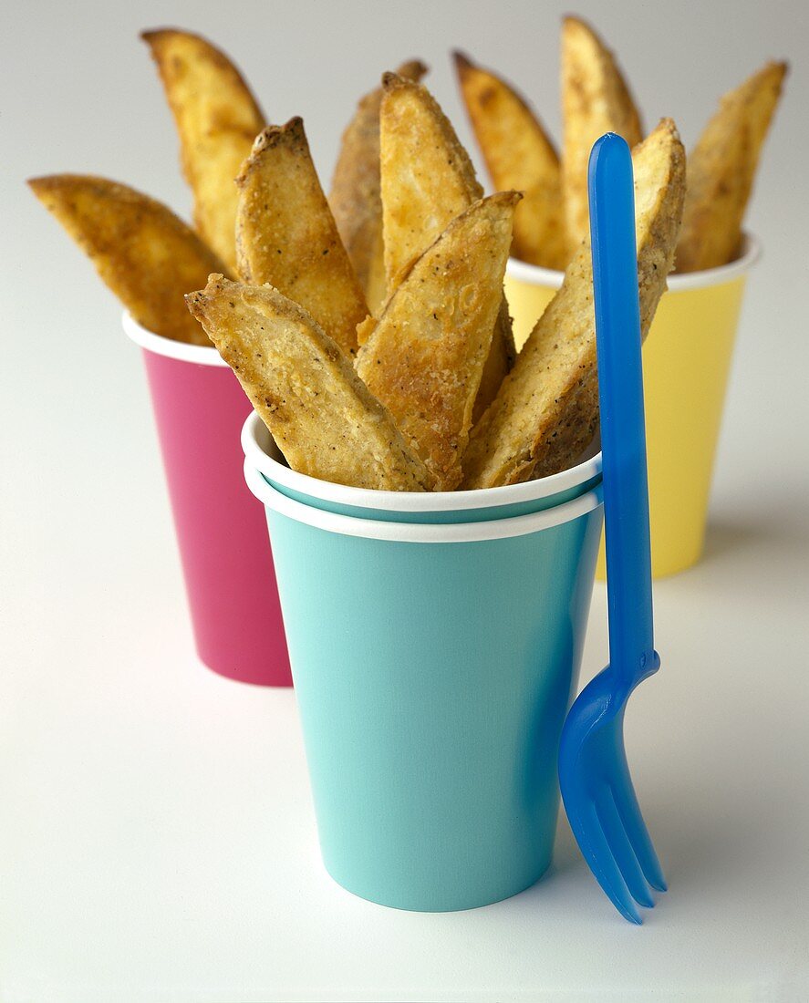 Potato Wedges in Paper Cups; Plastic Fork