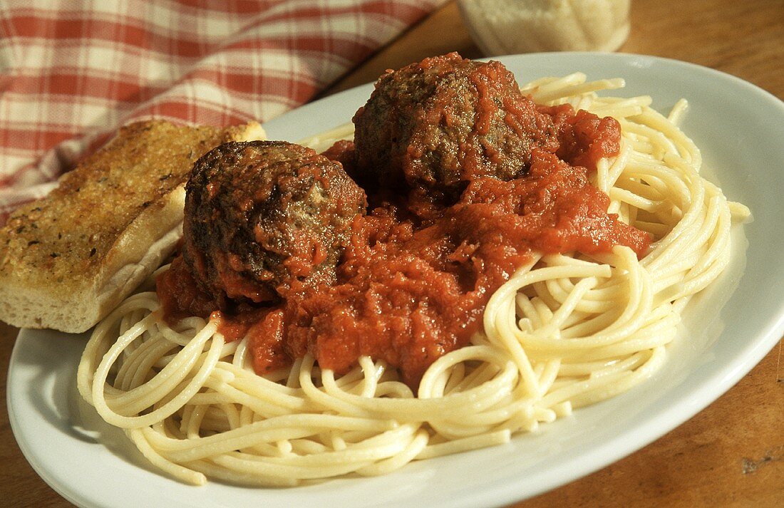 Two Meatballs and Tomato Sauce on Spaghetti with Garlic Bread