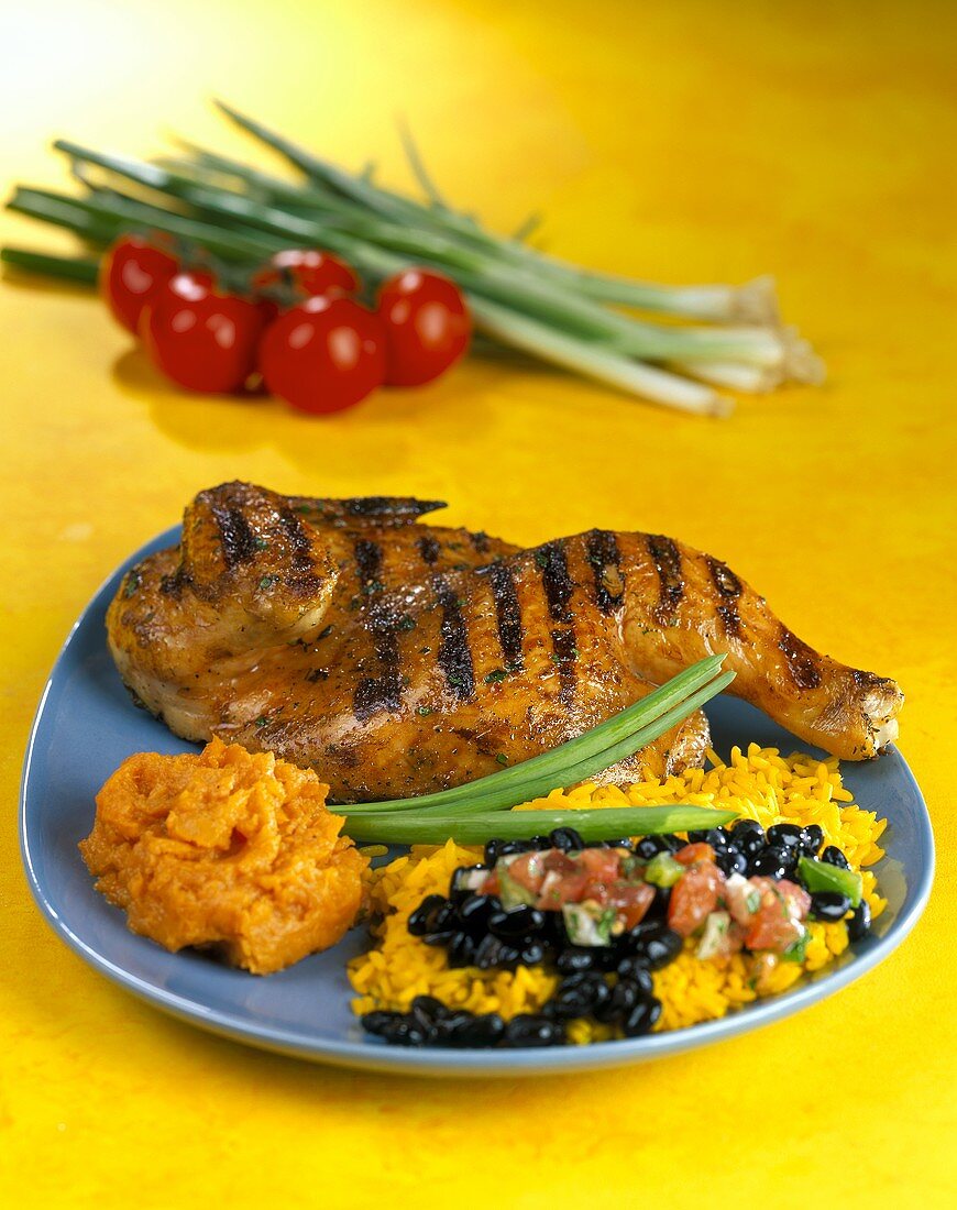Half a barbecued chicken with beans and rice